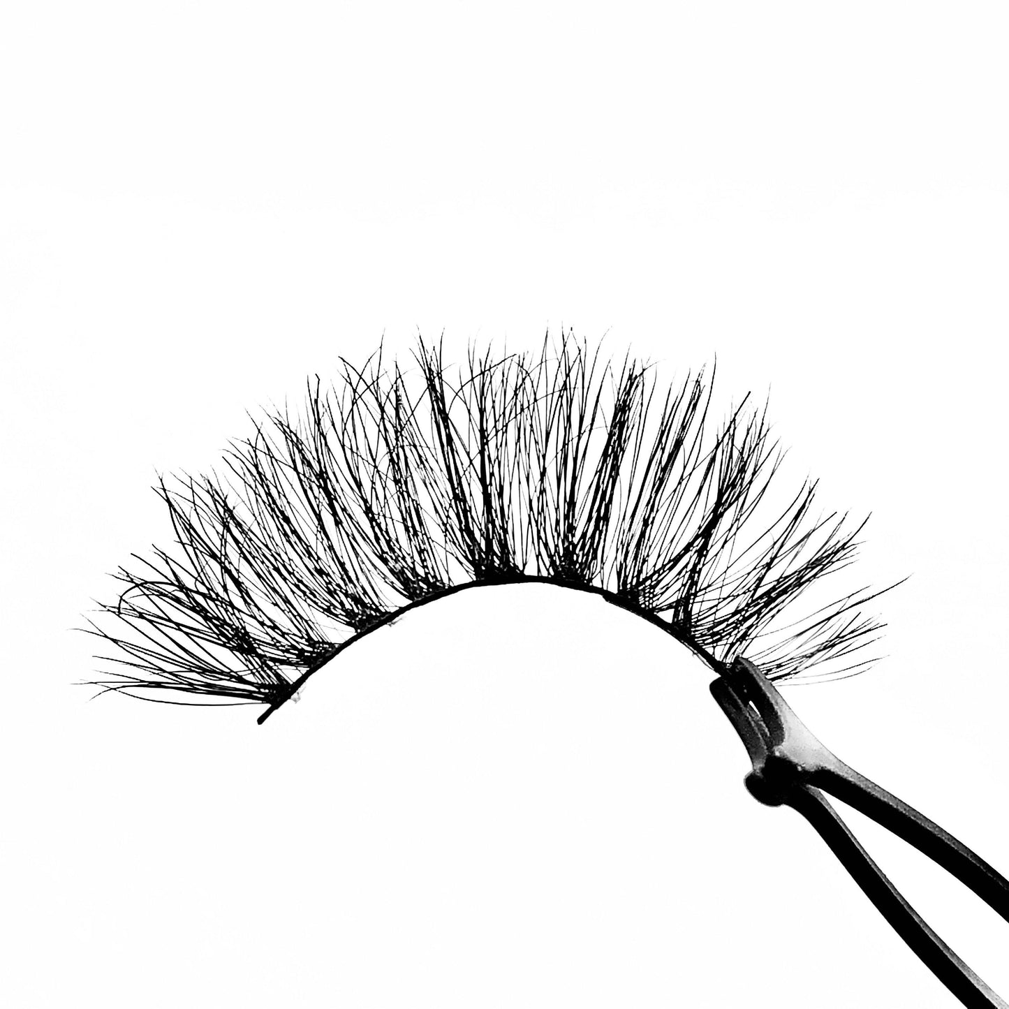 Halo-High Volume-You'll feel unbelievably confident in our mink lash style "Halo." These long, wispy lashes are perfect for a glamorous look. The longest hairs are located in the middle, creating a gorgeous eye opening effect that’ll make the whole world stop and stare! They’re super versatile and pair perfectly with a seductive, smokey eye look. Also available in our "Dramatic (3-Pack)" Description Handmade, Cruelty-Free, Wear up to 30x Material: 100% Mink Band: Thin, Black Cotton Band Volume: