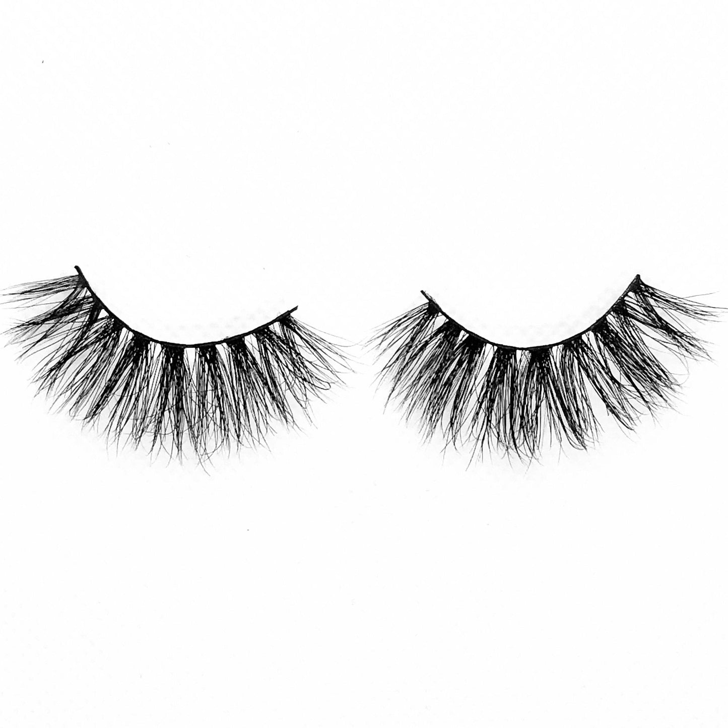 Halo-High Volume-You'll feel unbelievably confident in our mink lash style "Halo." These long, wispy lashes are perfect for a glamorous look. The longest hairs are located in the middle, creating a gorgeous eye opening effect that’ll make the whole world stop and stare! They’re super versatile and pair perfectly with a seductive, smokey eye look. Also available in our "Dramatic (3-Pack)" Description Handmade, Cruelty-Free, Wear up to 30x Material: 100% Mink Band: Thin, Black Cotton Band Volume: